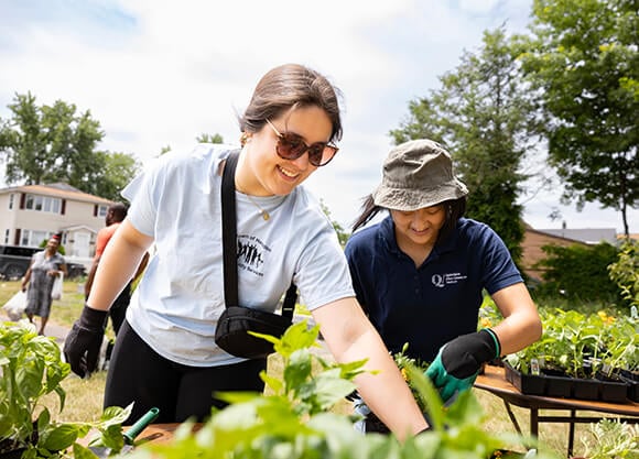 Two individuals planting a garden