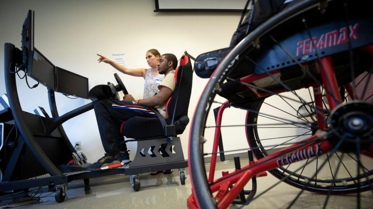 A student learns how to drive a simulated vehicle.