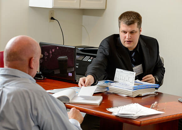 Students assists a local resident with taxes