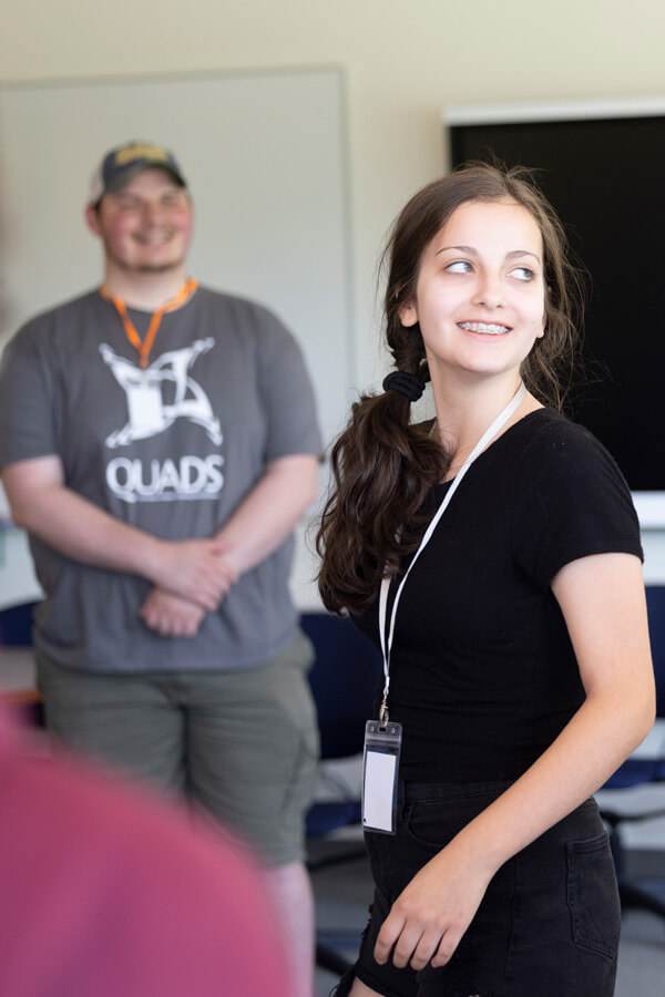 QUADS participant smiles during a demonstration.