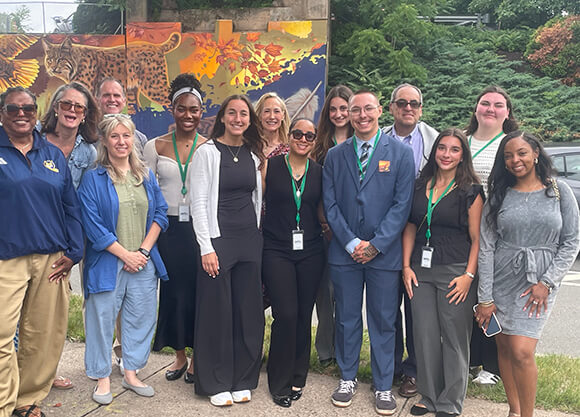 Quinnipiac and Hamden leaders celebrate unveiling of mural