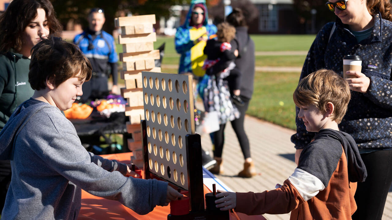 Two kids playing Connect 4 with each other