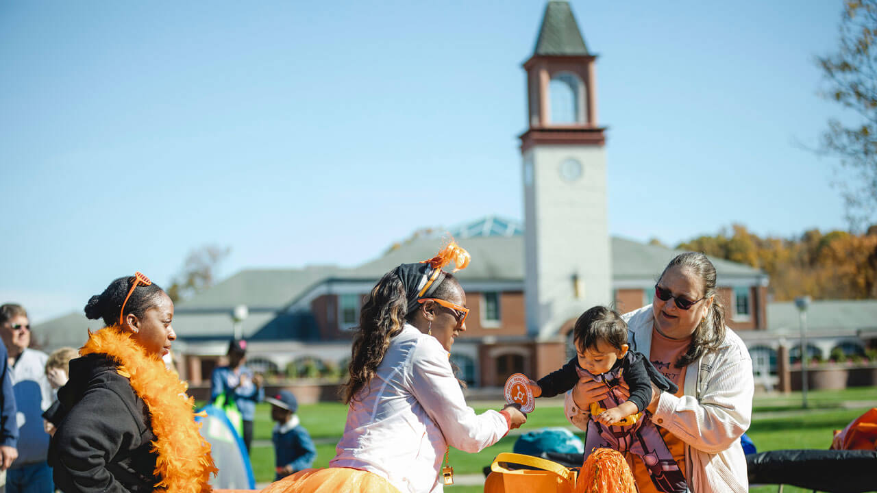 Child dressed in costume taking a piece of candy