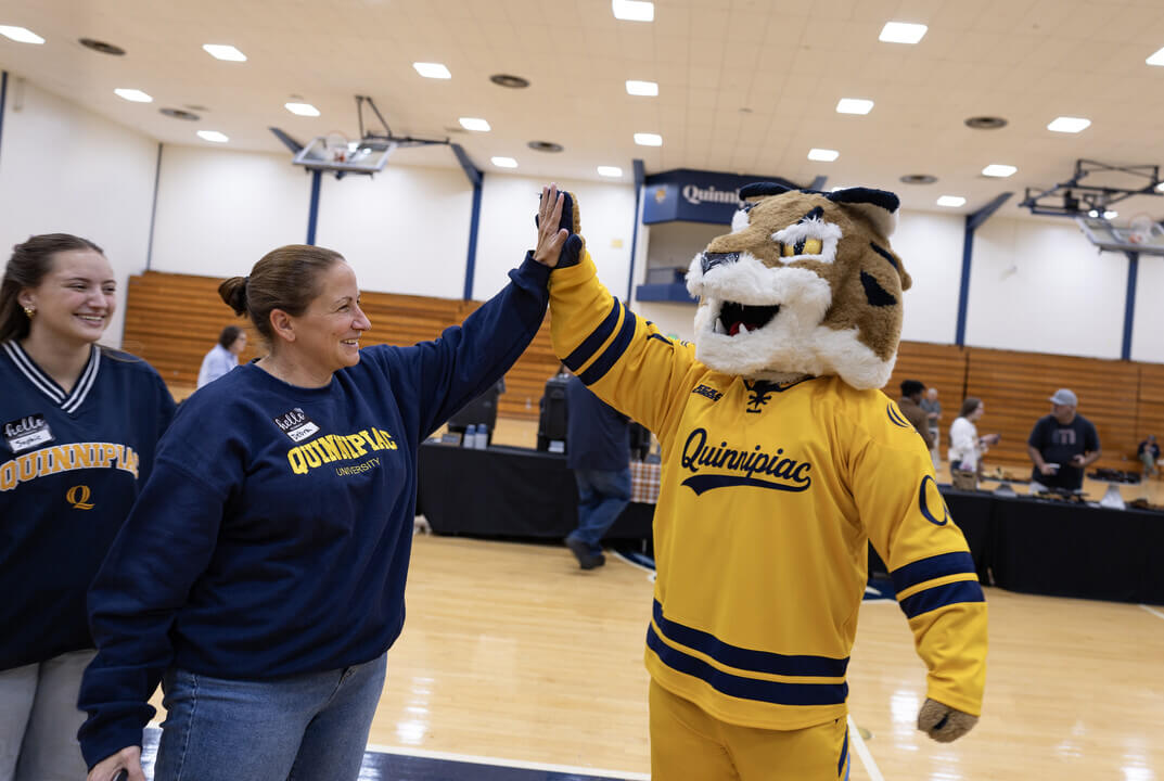 Boomer and alumna high five.